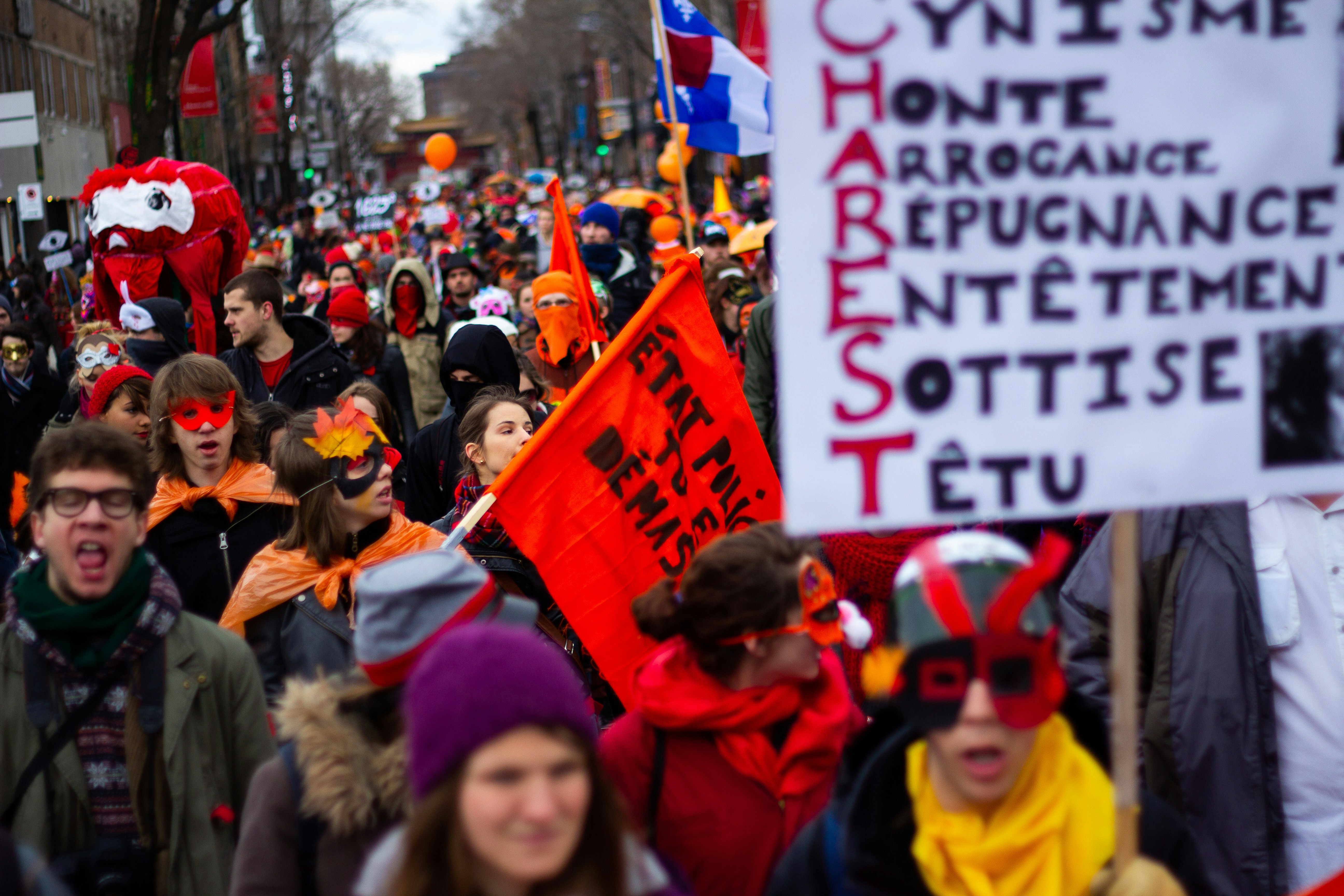 a group of people holding signs, Great mascarade during the student protests against the tuition fee rise in Quebec, Canada, in 2012