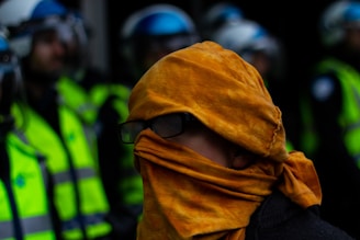 Trainer demonstrating safety procedures to a group wearing high-visibility vests.