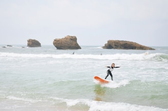 Girl surfing at luxury coastal getaway in Biarritz