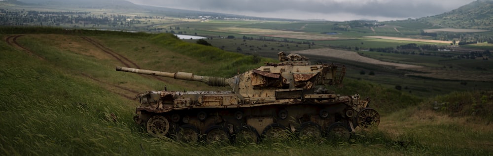 a military tank driving through a field
