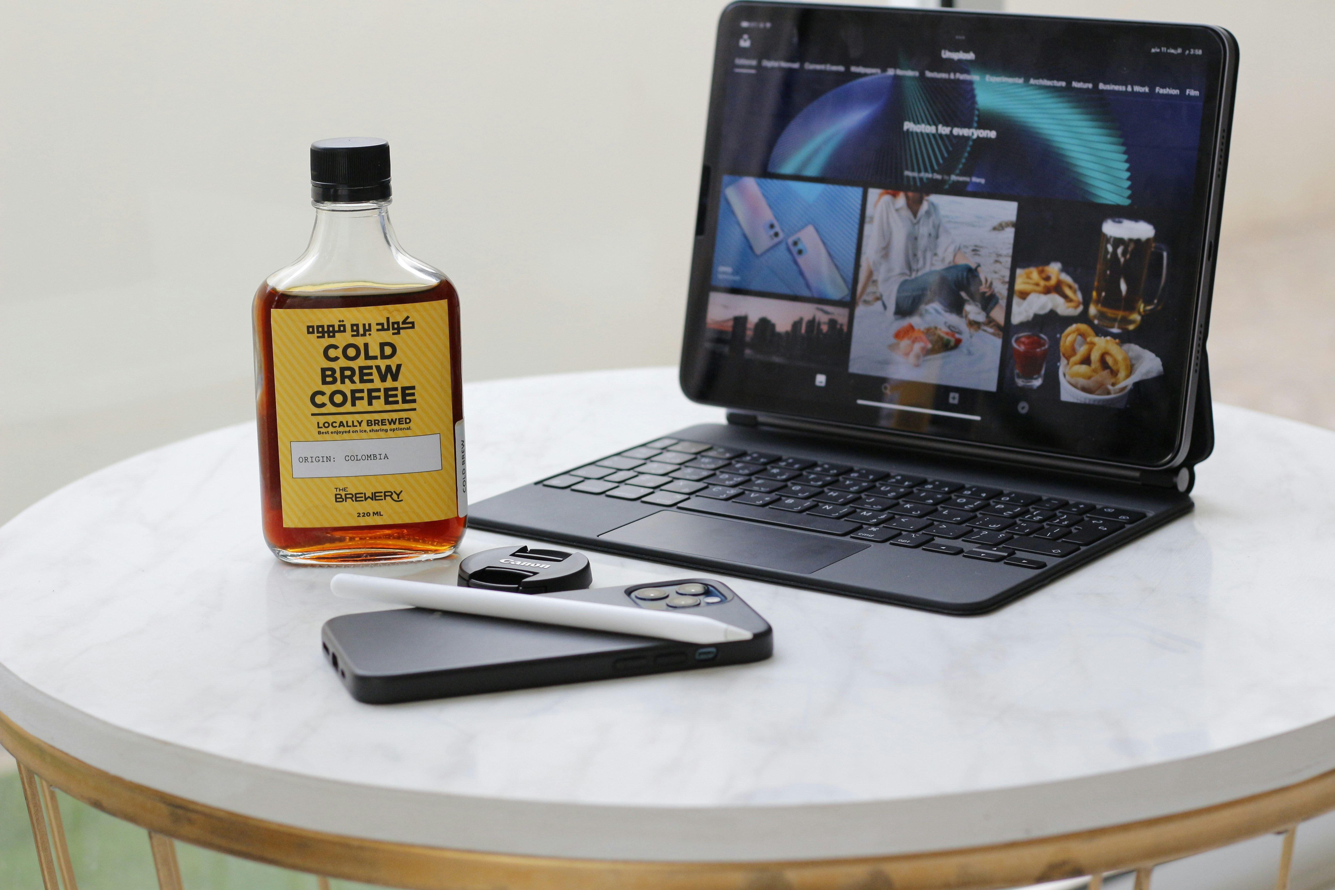 a laptop and a bottle of oil