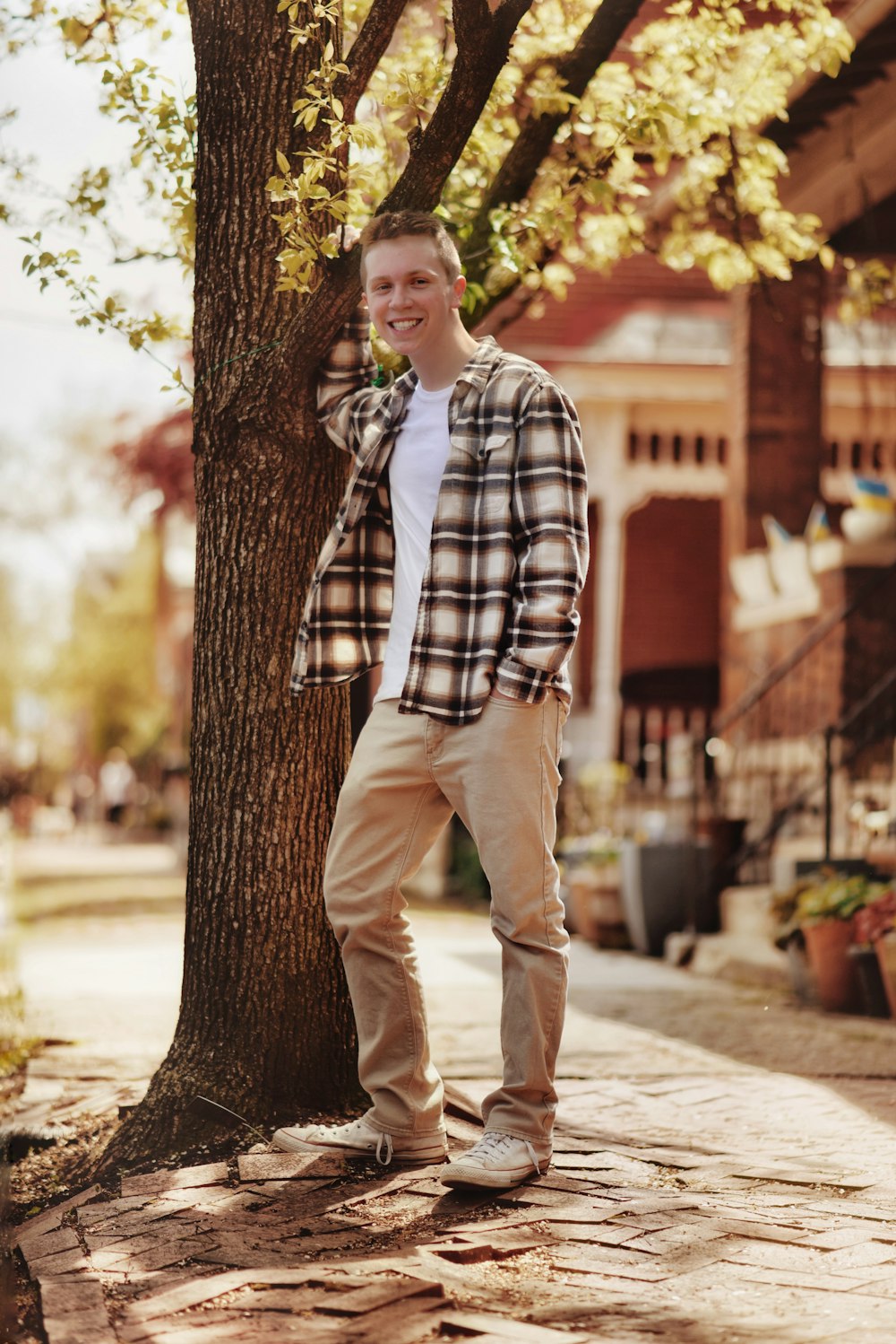 a man standing next to a tree