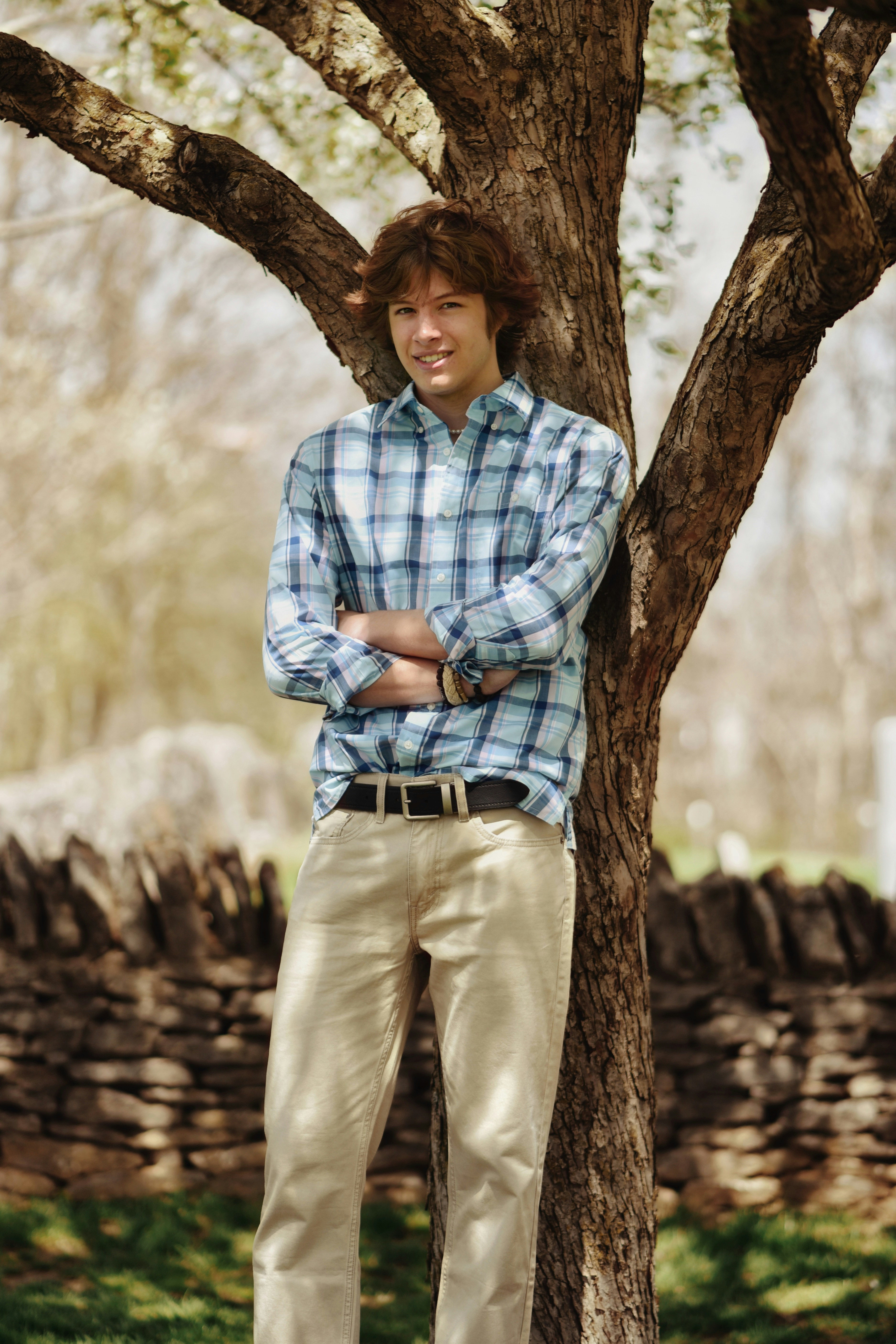 a man standing next to a tree