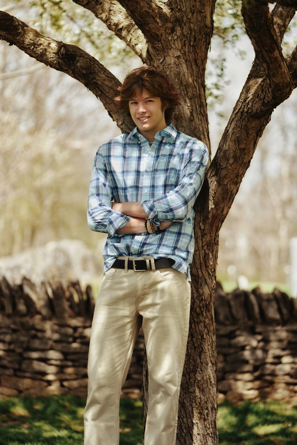 a man standing next to a tree