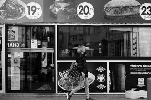 Lifestyle photo of a model walking through a sunlit Istanbul alley.