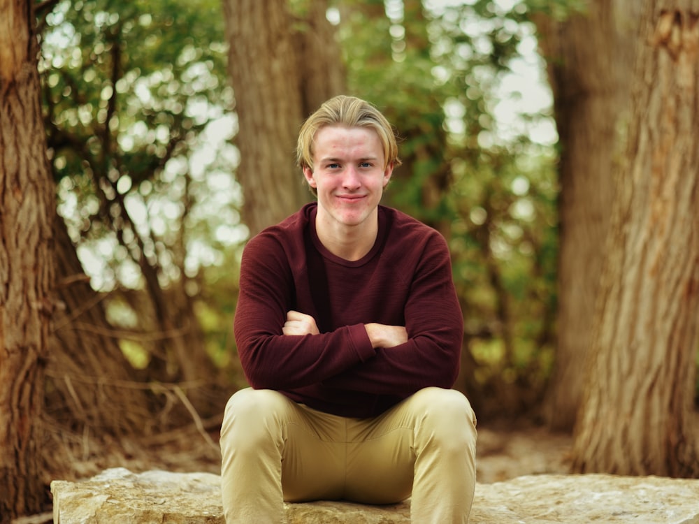 a person sitting on a rock