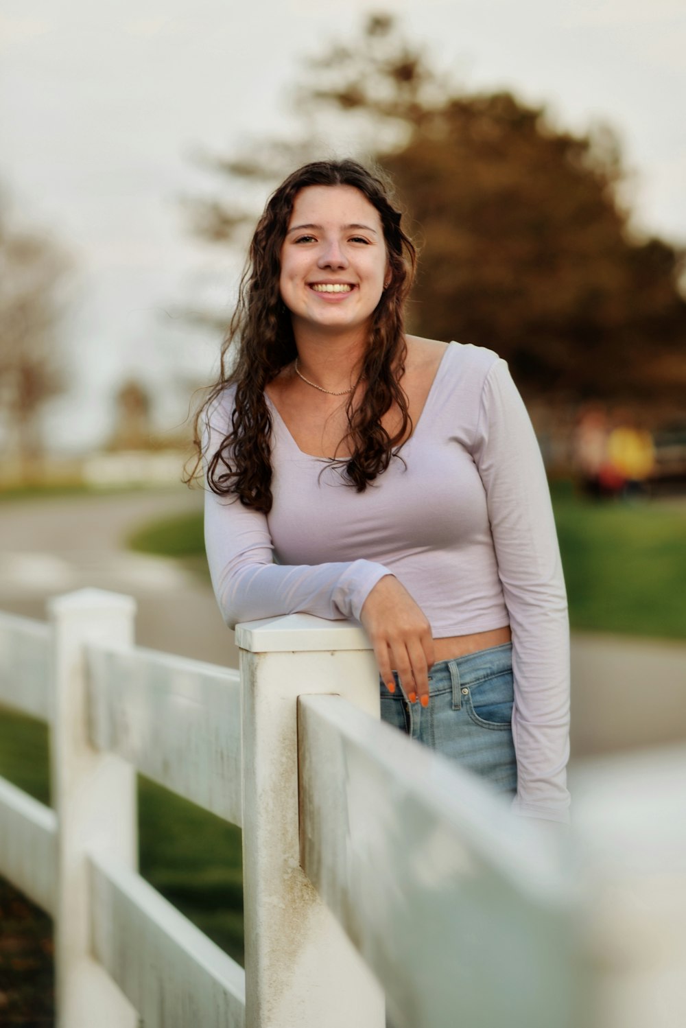 a woman leaning on a white railing