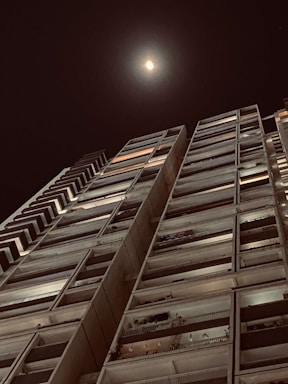 Elegant high-rise condo with balcony overlooking the Dubai skyline at dusk.