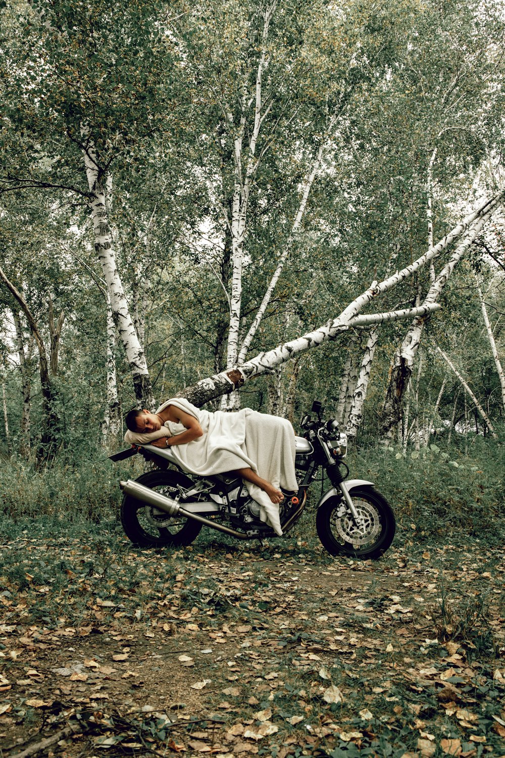 a person lying on a motorcycle