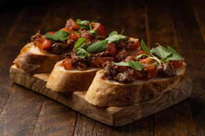 Traditional Calabrian nduja spread on fresh bread, garnished with herbs