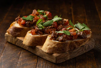Traditional Calabrian nduja spread on fresh bread, garnished with herbs