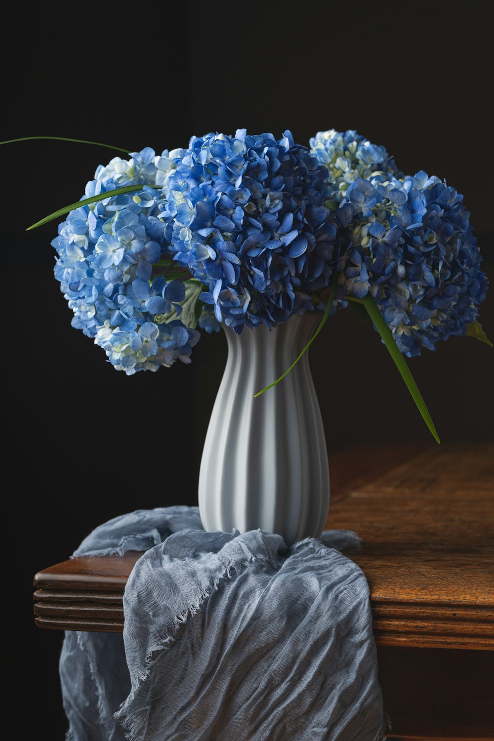 a vase with blue flowers