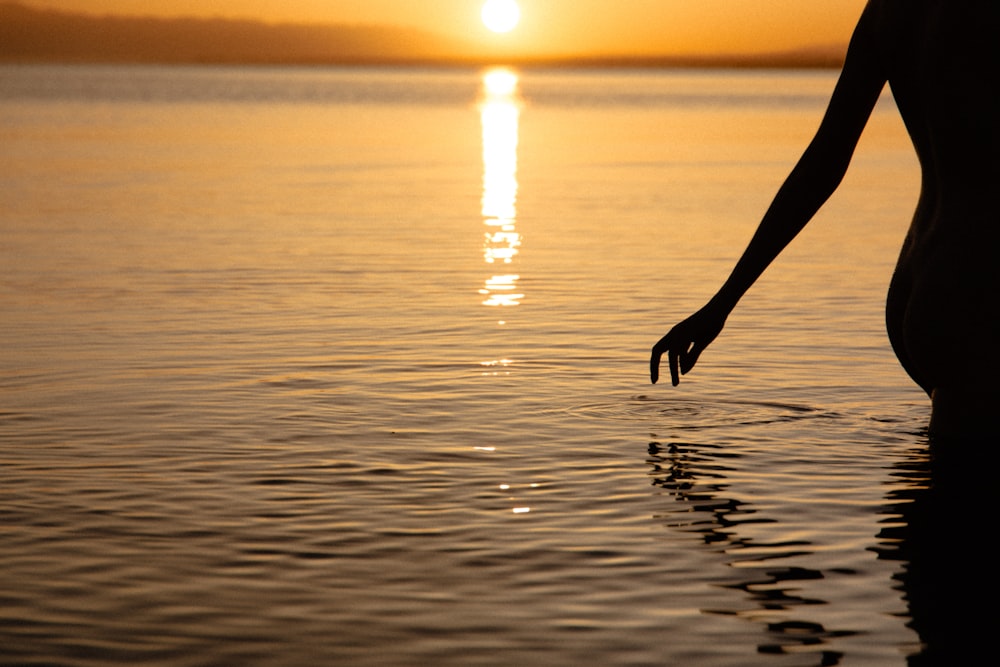 a person holding a paddle in front of a body of water