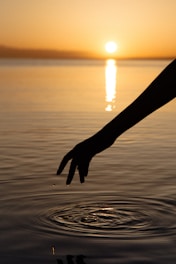 a hand holding a long metal rod