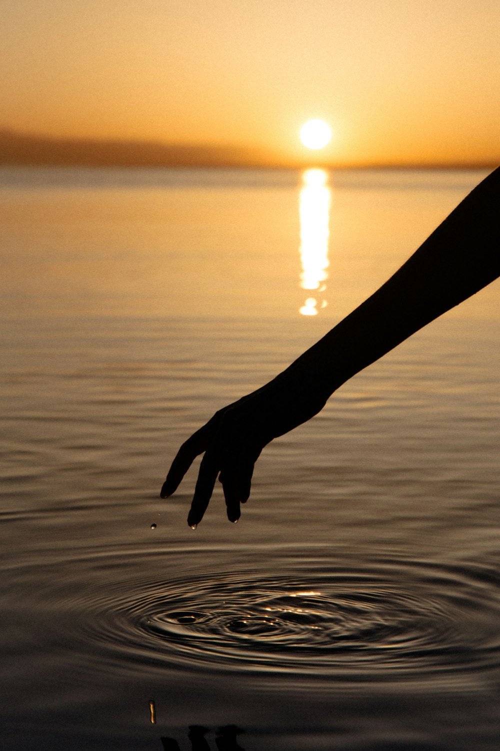 a hand holding a long metal rod