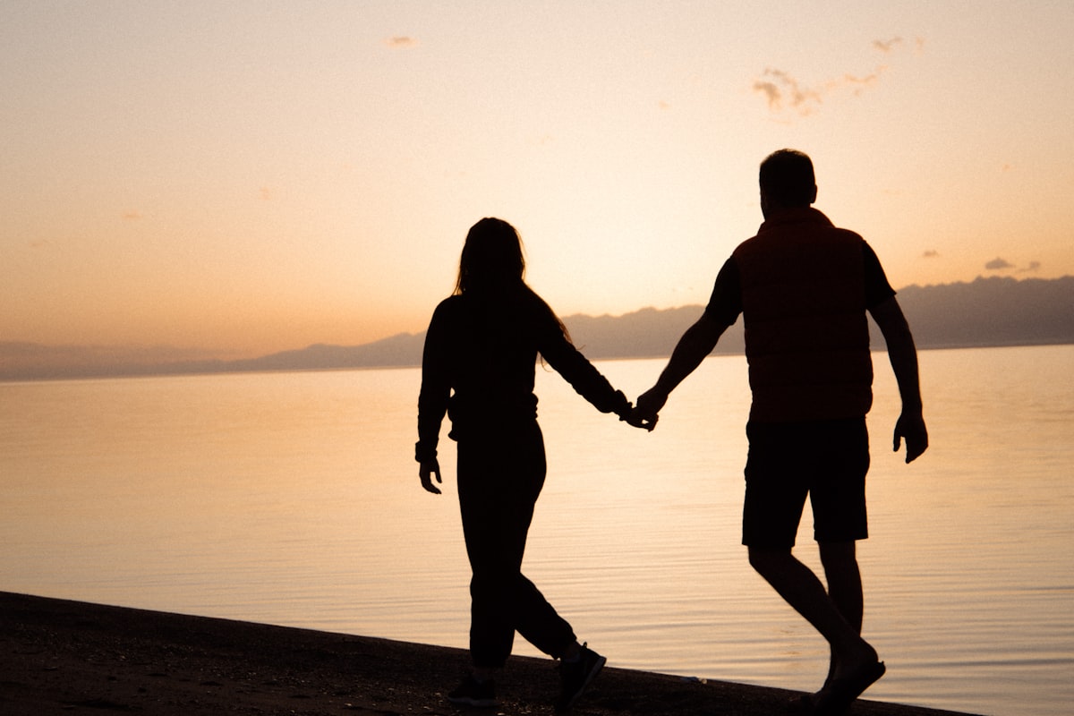 A man and woman holding hands together