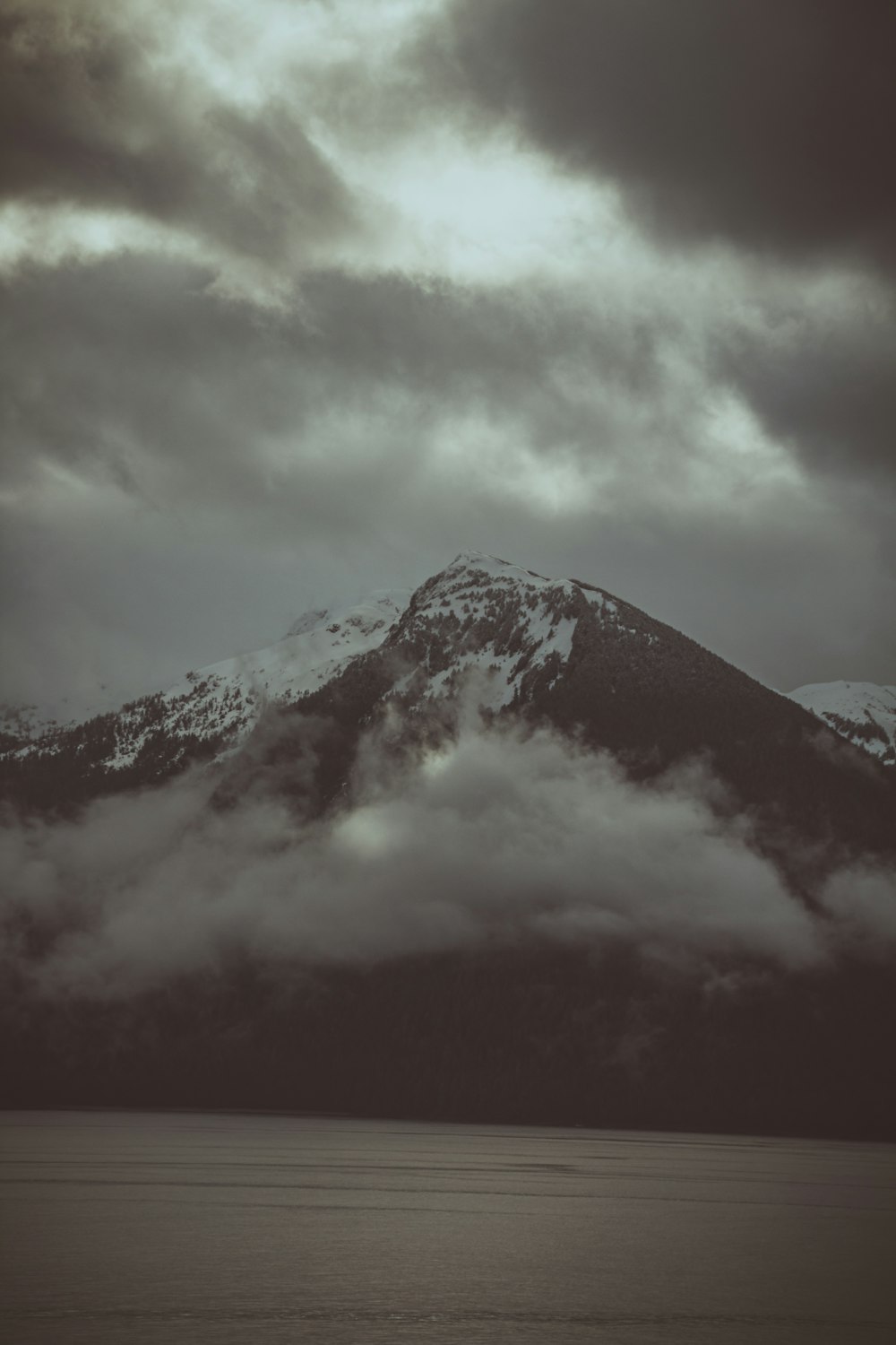 a mountain with clouds above it