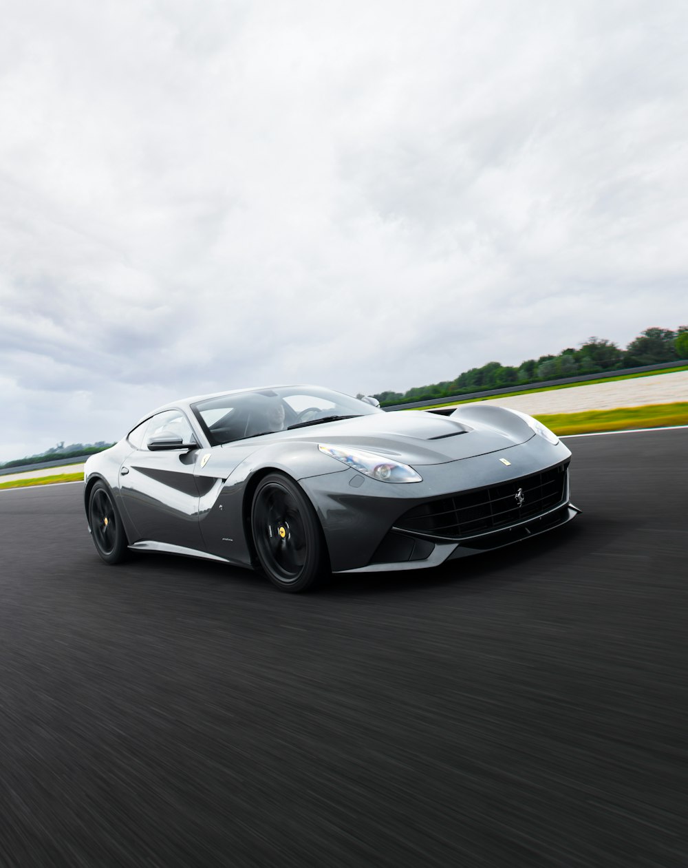 a silver sports car on a road