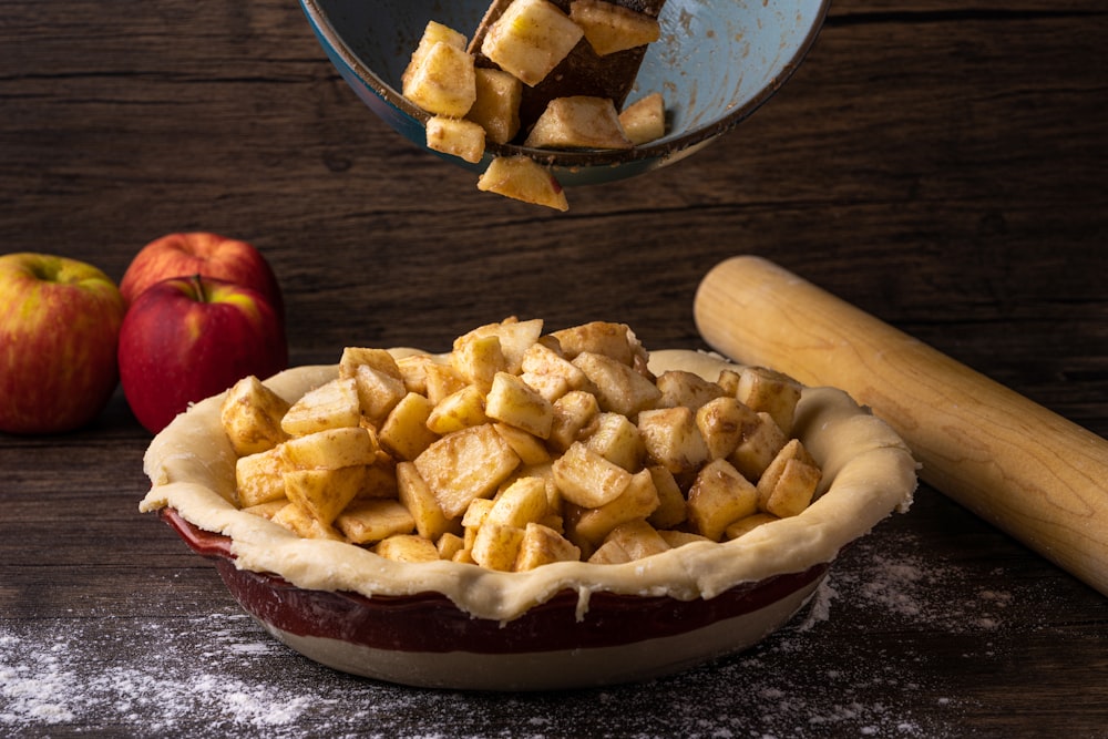 a pie with apples on the side