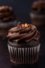 a cupcake with chocolate frosting and candy on top