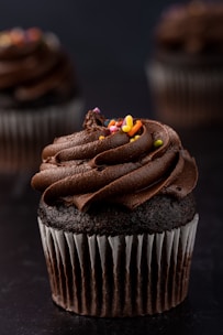 a cupcake with chocolate frosting and candy on top