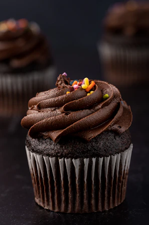 a cupcake with chocolate frosting and candy on top