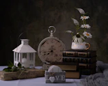 Warm editorial style photo of a spiral book holder beside a vintage clock.
