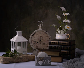 Warm editorial style photo of a spiral book holder beside a vintage clock.