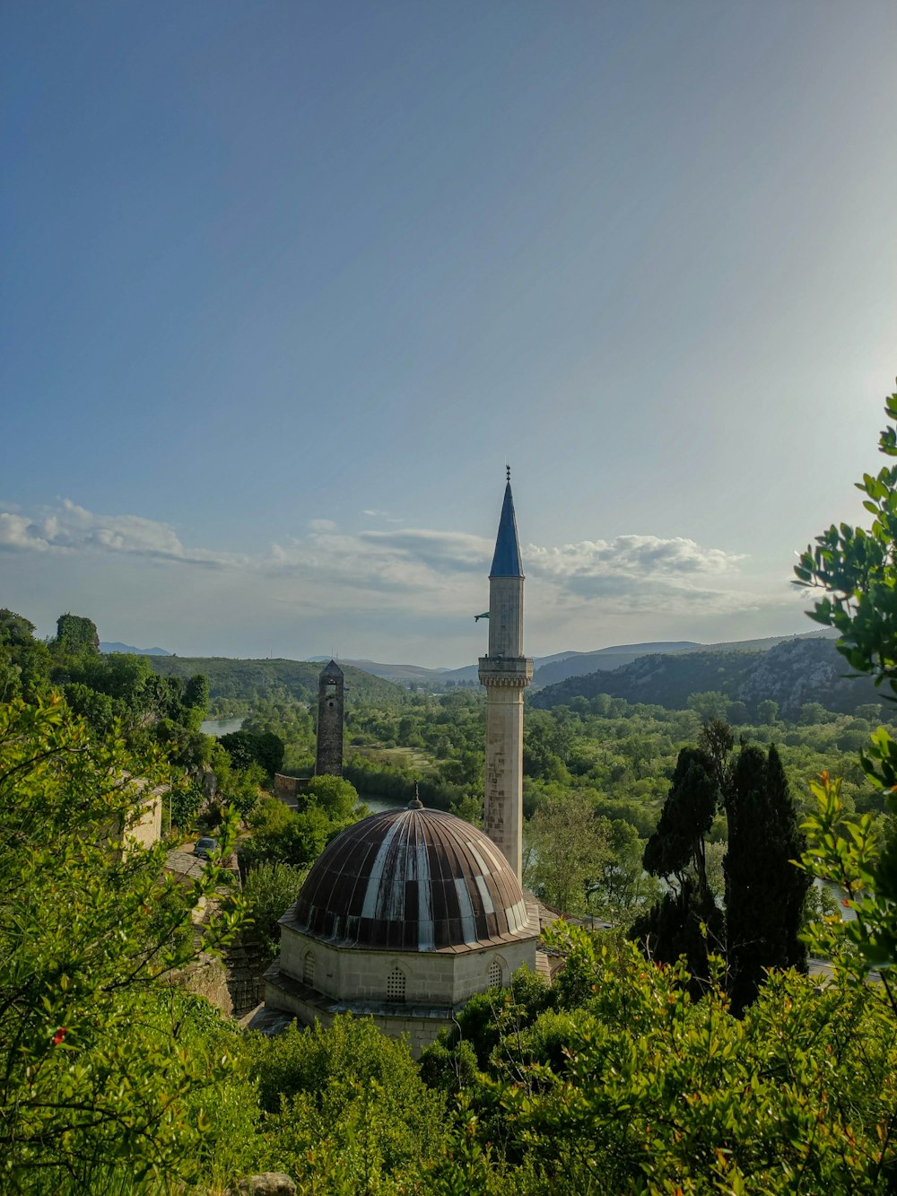 a dome shaped building with a tower in the background