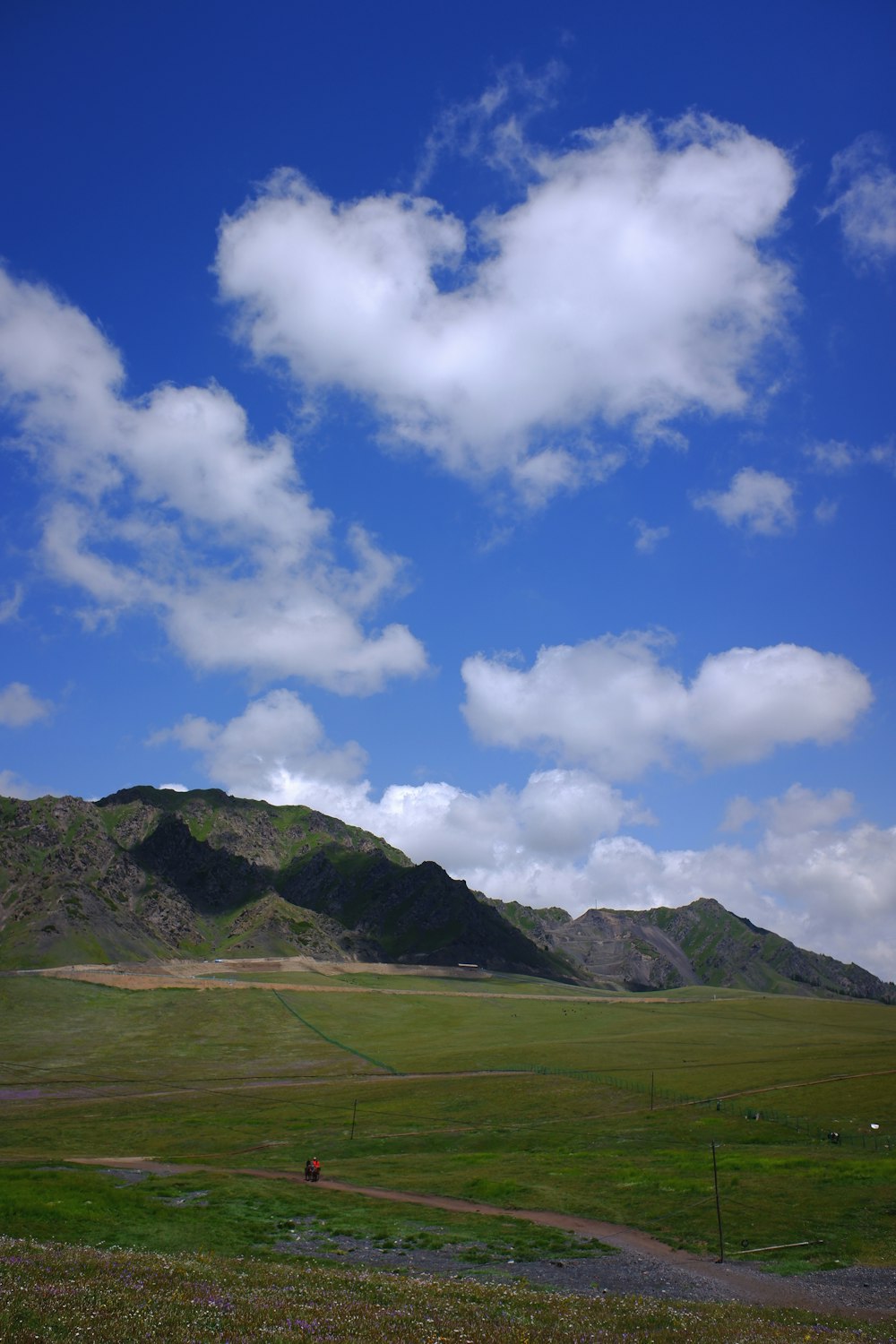 a landscape with hills and clouds