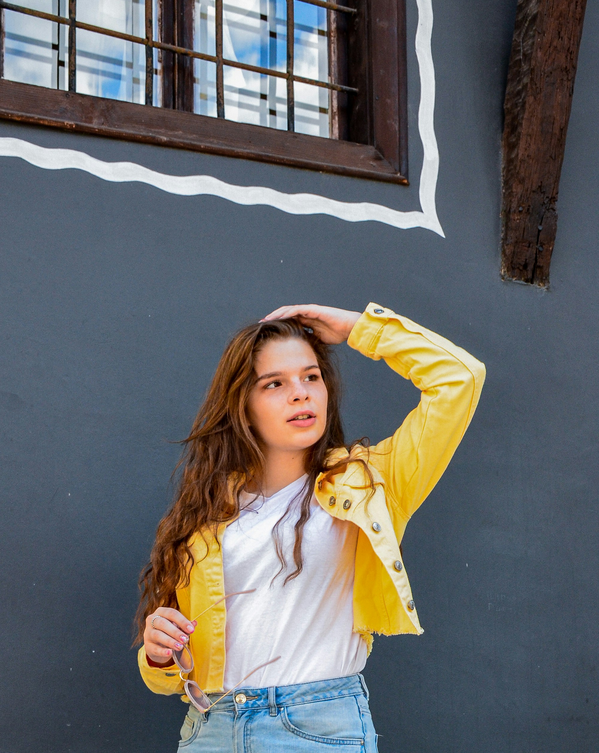 a girl with her hands on her head