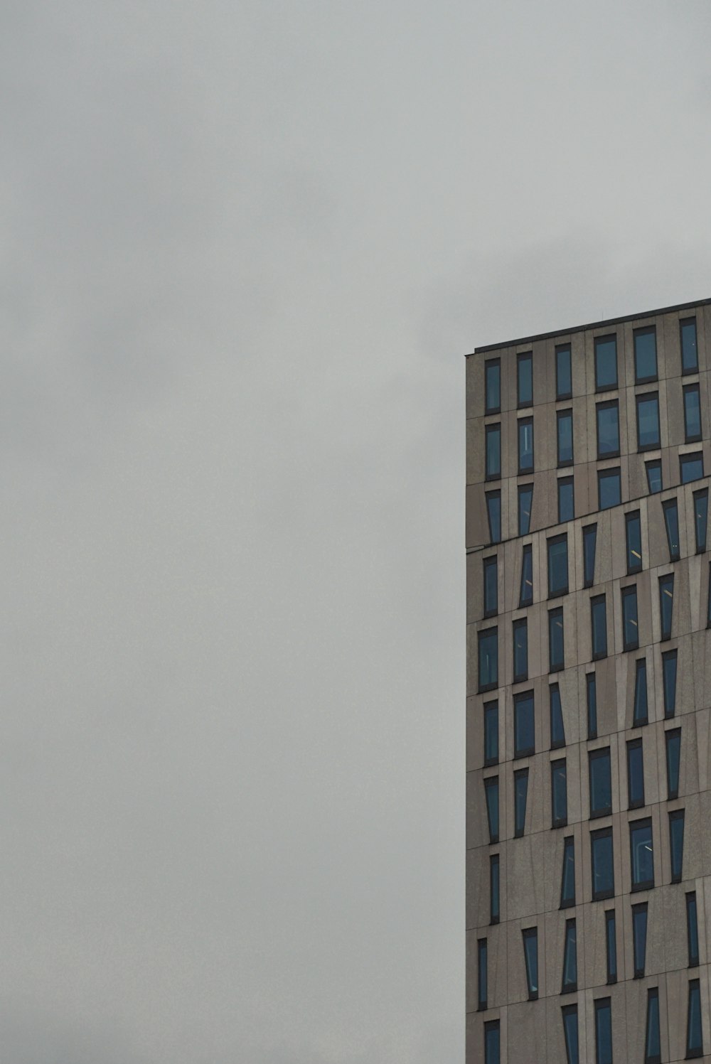 a tall building with a cloudy sky