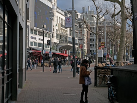 A vibrant small city street scene showing families, students, and local businesses connected by digital lines symbolizing the Digigreenhub ecosystem.