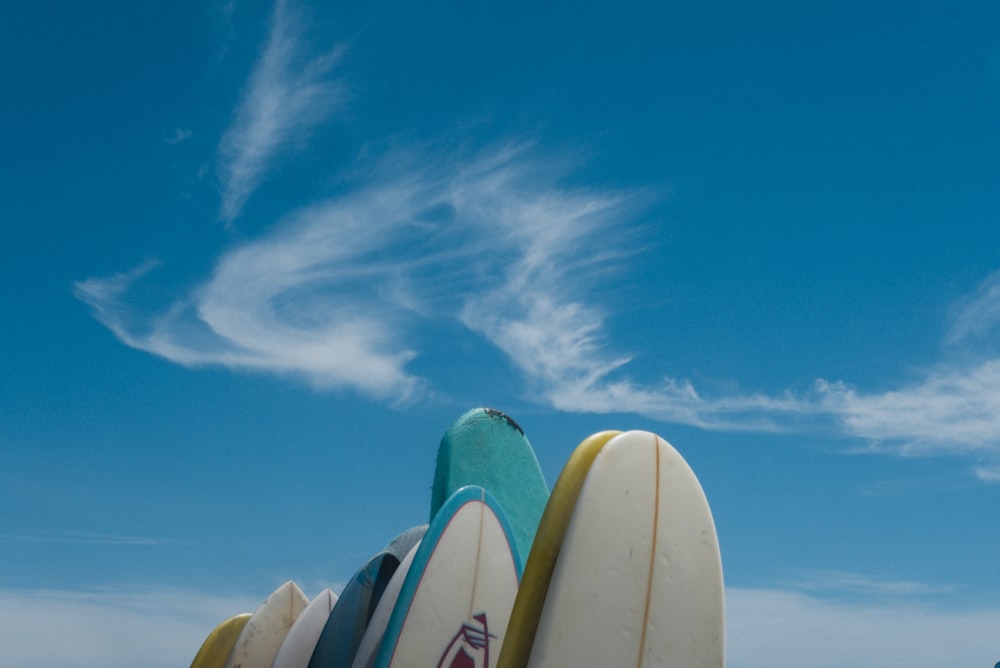 a group of surfboards against a blue sky