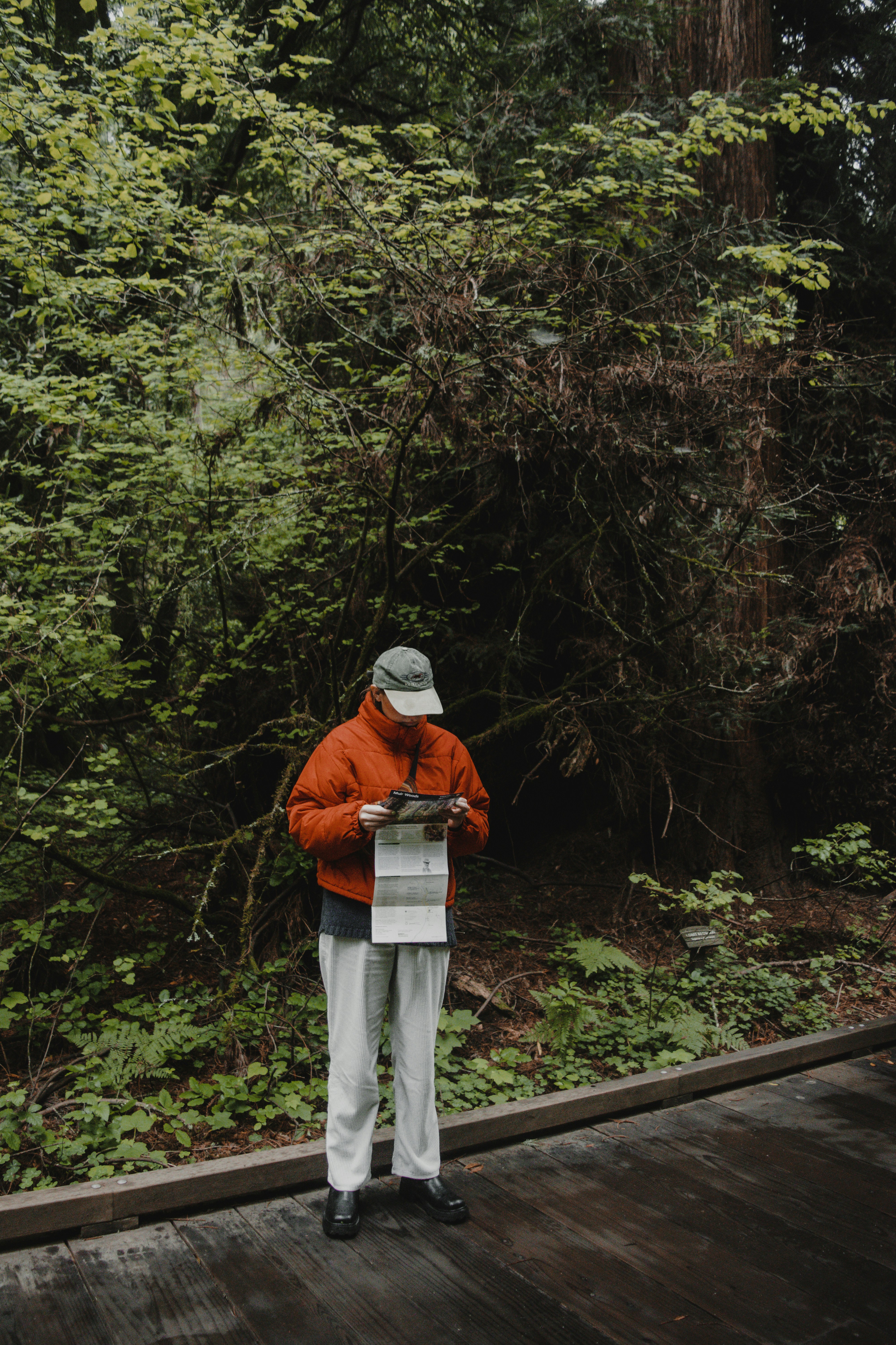 a man standing on a wooden bridge