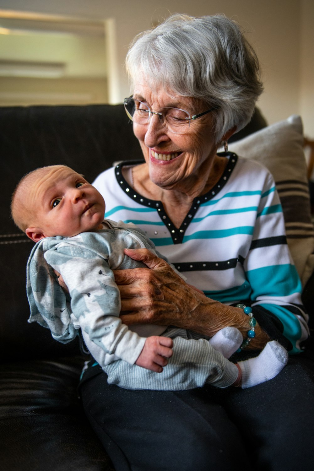 an older woman holding a baby