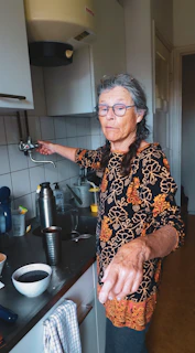 a man with tattoos in a kitchen