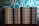 Two stacks of books are arranged, each book with a title that reads 'Team Lead Succeed.' The author's name, Nick Fewings, is visible on the spines. The books are neatly placed on a wooden surface, in front of a decorative background with intricate teal and cream patterns.