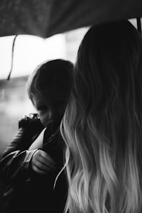 3D animated image of a family protected under a large umbrella.