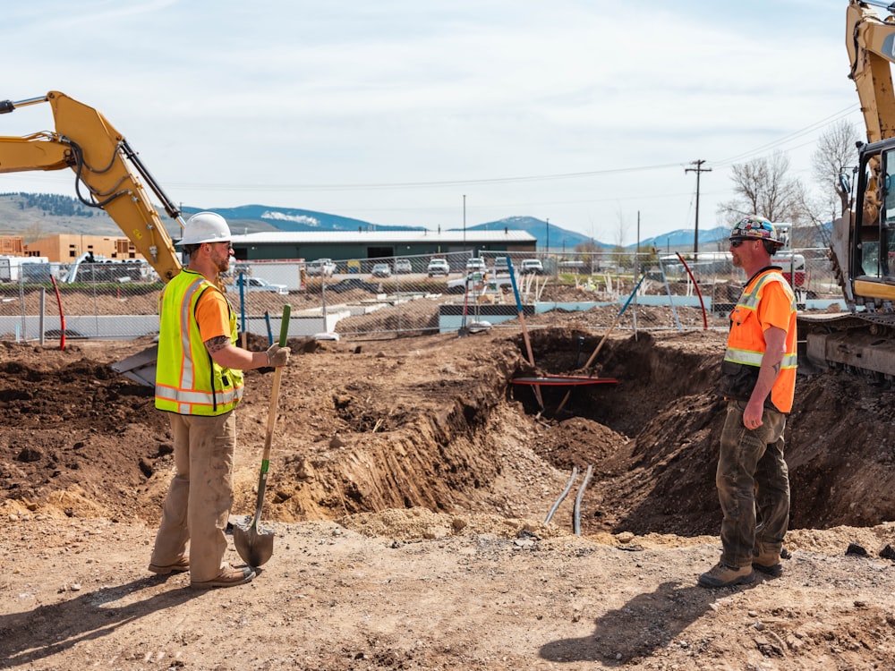 men in safety vests working on a construction site