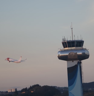 An airplane taking off into a clear sky, representing the beginning of a new journey abroad.