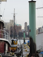 Marine service team inspecting equipment on a vessel’s deck with the city skyline in the background.