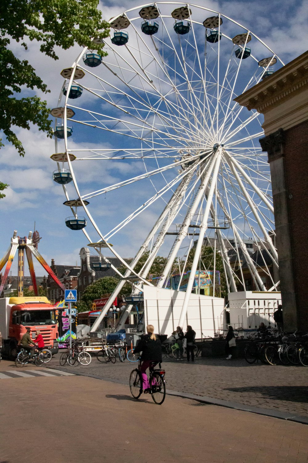 a ferris wheel with people riding bikes