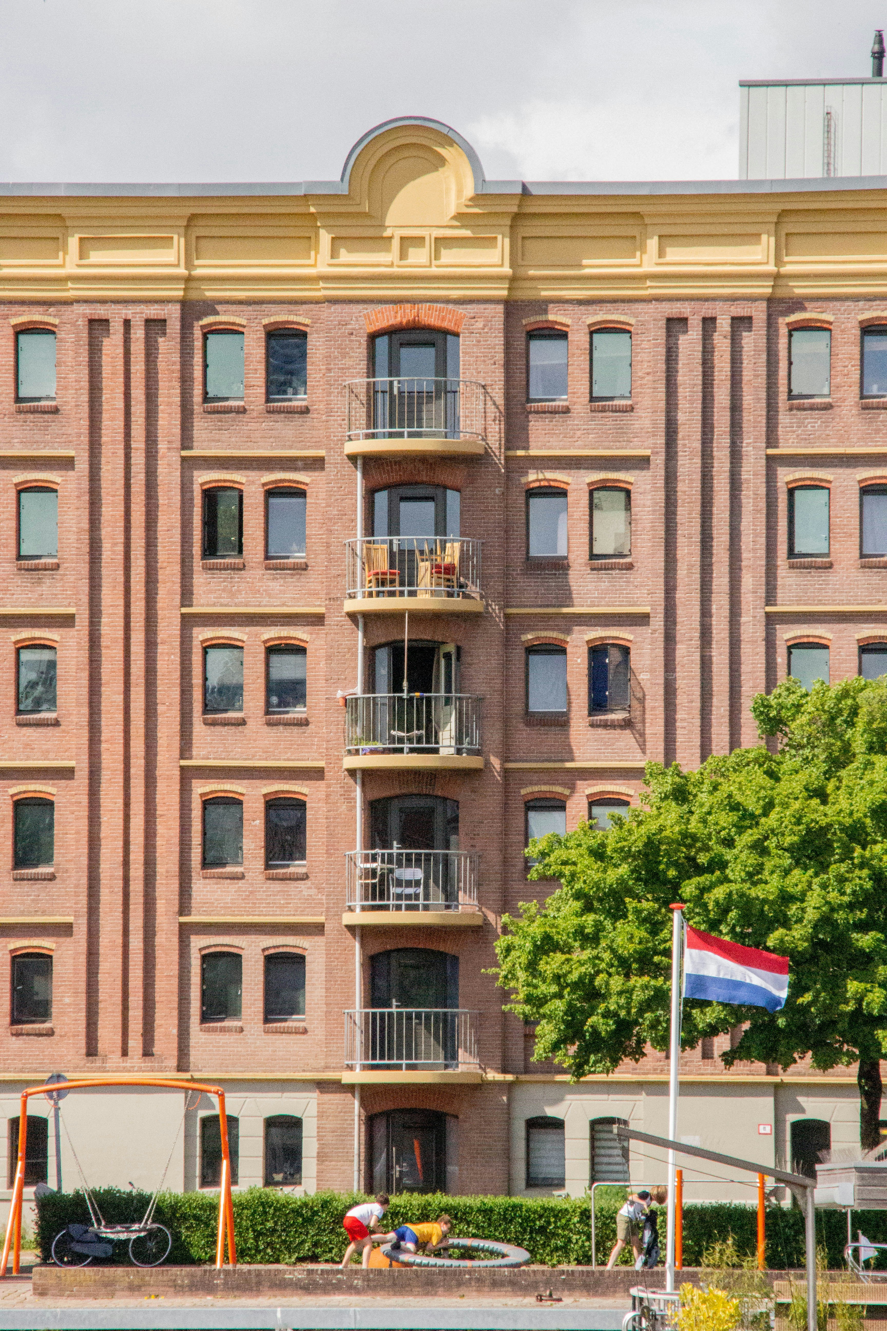 A building with a flag in front photo – Free Old building Image on Unsplash