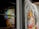 Two colorful, abstract portraits cover the walls, with vivid brushstrokes creating expressive faces. Bold, contrasting colors enhance the lively nature of the portraits, which seem to capture a sense of motion and emotion.