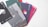 A collection of color sample cards, each labeled with a number and a color name. The cards have different shades such as black, gray, green, blue, and red. They are fanned out on a light surface, and each card has a cutout design.
