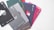 A collection of color sample cards, each labeled with a number and a color name. The cards have different shades such as black, gray, green, blue, and red. They are fanned out on a light surface, and each card has a cutout design.