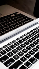 A technician repairing a MacBook keyboard.
