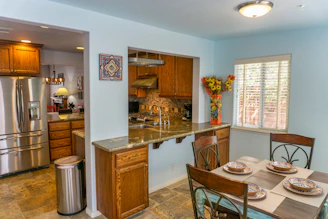 a kitchen with a table and chairs
