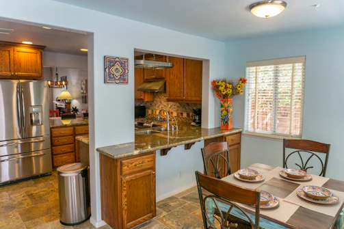 a kitchen with a table and chairs